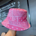 Close-up detail of the pink paisley pattern and fabric texture on a fashion bucket hat - One Size / Pink