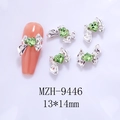 Detailed macro of silver alloy bow nail charms with green heart zircon 13x14mm size - Silver Bowknot Green Heart(9446)
