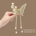 Detail of golden metal butterfly hair claw with white flowers and long pearl tassels - White Flower Butterfly