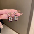 Detail of gold-plated butterfly earrings with colorful crystals and pearls held by hand - 31# Silver Pin - Multicolor (Crystal Zircon)