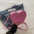 Pink heart-shaped PU leather crossbody bag with embossed patterns and gold zipper - Pink