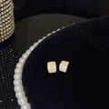 Elegant cream enamel rectangle stud earrings with gold trim on black velvet display - A187 Gold-Cream Square