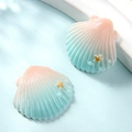 Detailed close-up of resin shell charms with pink-blue gradient and golden starfish - Small / Champagne + Blue