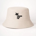 Detail of cream bucket hat featuring black palm tree print and Beaches Love Me text - Beige