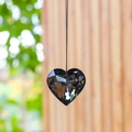 Dark gray heart crystal suncatcher pendant hanging against a natural greenery background - 30MM / Transparent Black