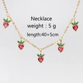 Detail of strawberry necklace with red heart-shaped crystals and 5cm extension chain - Gold Strawberry Necklace