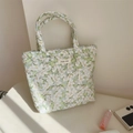 Detail of floral quilted tote bag with simple wish label and soft natural lighting - Green Gardenia