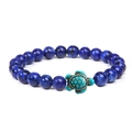 Detailed view of elastic bracelet with blue natural beads and a turquoise turtle charm - Lapis Lazuli