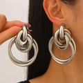 Chunky silver multilayered hoop earrings with a metallic finish on a female model - Large Silver Multi-hoop Nested (11281)