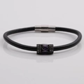 Macro detail of black leather bracelet with purple stone inlay and magnetic clasp - Black Leather + Purple Stone