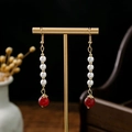 Detail of long drop earrings with white pearls and red agate bead on a gold stand - Four Pearl Red Agate Tandem (E205)