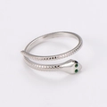 Detailed macro view of silver snake ring featuring green gem eyes and scale texture - US 6 / Silver