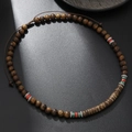 Close-up of wooden beads necklace with colorful turquoise accents and silver spacers - Dark Brown Wood Red/Green (ZJ12525)