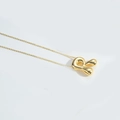Polished gold bubble letter R pendant necklace with mirror finish in minimalist style - Letter R