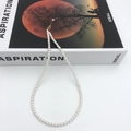 Detail of white pearl necklace with gold-plated adjustable clasp on minimalist book - 14K Gold Filled 4mm (38+4cm)