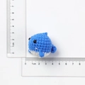 Handmade knitted blue whale keychain charm measuring 3cm by 3cm on white background - Detailed Blue Little Whale