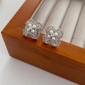 Detail of silver floral zircon earrings with pearls on a beige velvet jewelry box - Four-Petal Flower Pearl Earrings