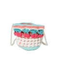 Detail of hand-knit bucket bag with 3D cherry accents and white faux pearl strap - Pink