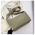 Detail of olive green quilted shoulder bag with white contrast stitching and wide strap - Green