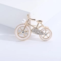 Elegant gold bicycle brooch with white enamel wheels, rhinestones and a faux pearl accent - Gold Edge White