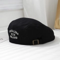 Detail of CATALINA 1983 embroidery and bronze buckle on a black cotton beret cap - 52cm (2-5 Years) / Black
