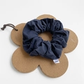 Dark blue fabric scrunchie with brand label on a flower shaped cork pad background - Large / Navy Blue