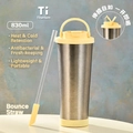 Detailed macro view of 830ml pure titanium bottle with yellow lid and pop-up straw - 830ml / Cream