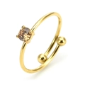 Detail of adjustable gold ring featuring a champagne round-cut stone in four-prong setting - One Size (Adjustable) / Champagne Zirconia