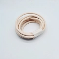 Macro detail of 6mm off-white leather cord showing fine texture and stitched edges for DIY - Beige