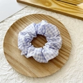 Blue and white gingham fabric scrunchie with classic checkered pattern on a wood tray - Light Purple Plaid