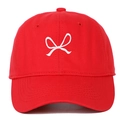 Close-up of a red baseball cap featuring a white embroidered bow on the front panel - Red