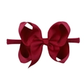 Close-up of a red ribbed fabric bow attached to a soft elastic nylon baby headband - Red