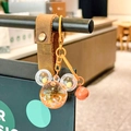 DIY Mickey-shaped liquid keychain with orange glitter stars and brown leather strap - Yellow Mickey Head Sparkle