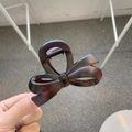 Close-up of tortoise shell bow hair claw clip with durable metal spring detail - Approx. 8cm / Matte Red Brown