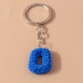 Blue letter O keychain featuring rose floral relief and polished silver metal ring - Letter O