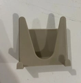 Dettaglio di un supporto a parete beige per coperchi o spugne in materiale plastico opaco - Caffè Chiaro