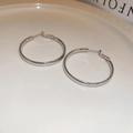 Close-up of polished silver hoop earrings with smooth finish on a white tray - Silver Large Hoop (Silver Earring Post)