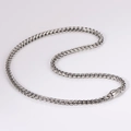 Macro shot of silver stainless steel braided chain necklace with polished metal link detail - Steel