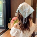 Light blue floral lace headscarf with ties worn by a model in a bright indoor cafe - Spring Day Heart Headband