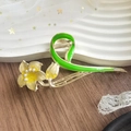 Golden tulip flower hair claw with green leaves and white bead accents on wood - Yellow Streamline Flower-YZAP45-21
