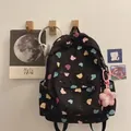 Black waterproof backpack with colorful bear prints and a pink flower plush charm - Black Bear