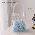 Light blue gift packaging inside transparent PVC handbag with snap button, size 15x12.5x8.5cm - 6# PVC Bag + Blue Raffia
