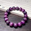 Detailed macro shot of purple burnt cat claw Bodhi root beads with intricate carvings - Purple Grape Carved Six Characters