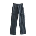 Detailed macro view of heavy-duty charcoal grey cargo pants with side flap pockets - Gray