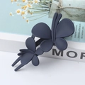 Elegant navy blue matte double butterfly hair clip displayed on a book for hair styling - Navy Blue