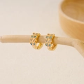Macro detail of gold-plated hoop earrings with turquoise stones and cubic zirconia - EH411018