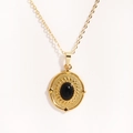Detail of 14K gold titanium steel necklace featuring a black oval stone and starburst texture - Round Black Cat Eye Star (Style 6)