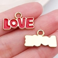 Golden heart charm with red enamel and LOVE text shown for size on a finger - Red LOVE Letter Plate (21186)