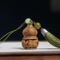 Handcrafted sandalwood gourd charm with auspicious carving and green silk tassel - Green Sandalwood Dragon Gourd - No Aroma Pill