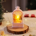 Detailed close-up view of a white Christmas lantern with warm deer scene on wooden base - White Reindeer